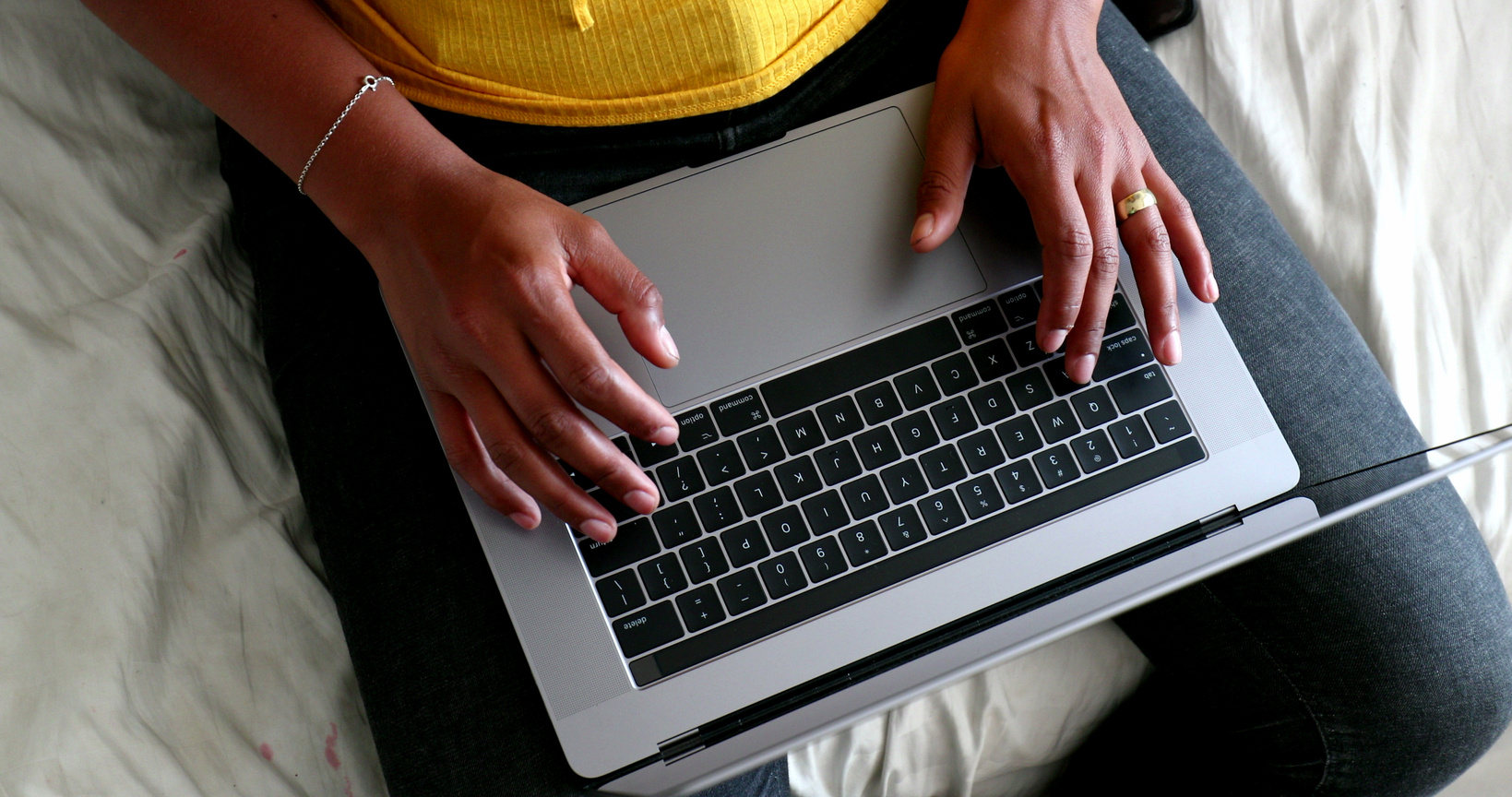 Black woman hands typing on laptop computer